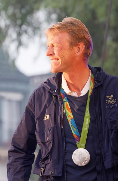 Smiling swedish show-jumper Peder Fredricson showing his medal