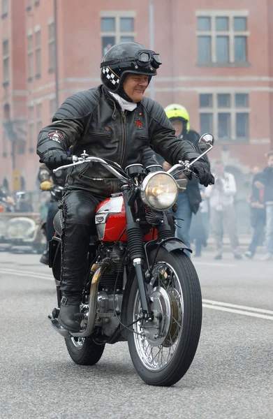 Biker wearing leather clothes on old fashioned motorcycle