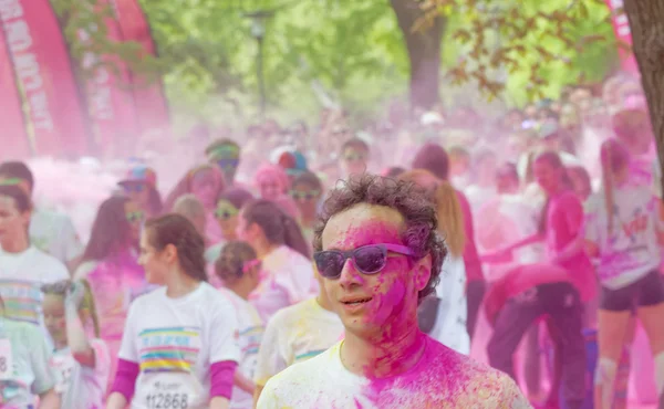 Man wearing sun glasses covered with pink color powder