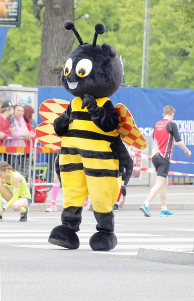 The mascot, a wasp, before the start of the marathon race