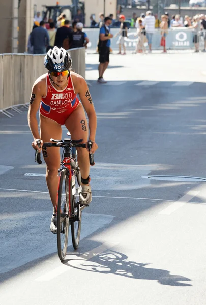 Triathlete Elena Danilova standing up cycling