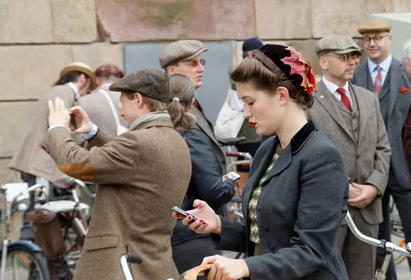 Group of people wearing old fashioned tweed clothes