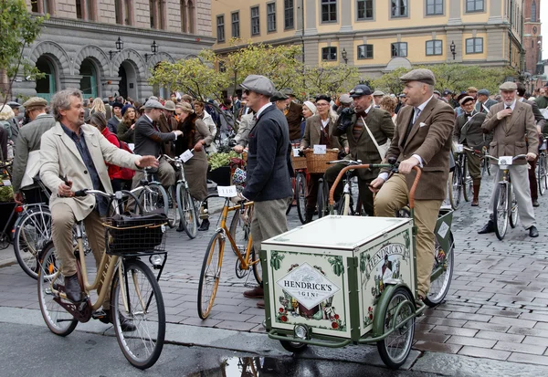 Group of elegant cycling people wearing old fashioned tweed clot