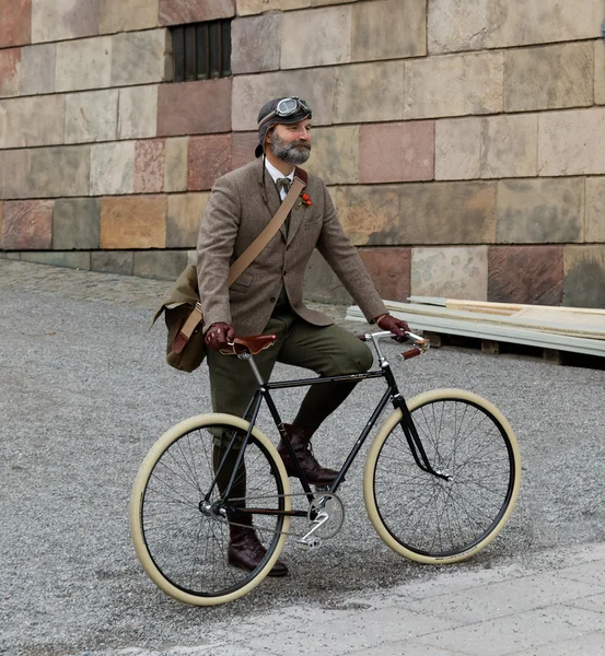 Man wearing old fashioned tweed clothes and bicycle