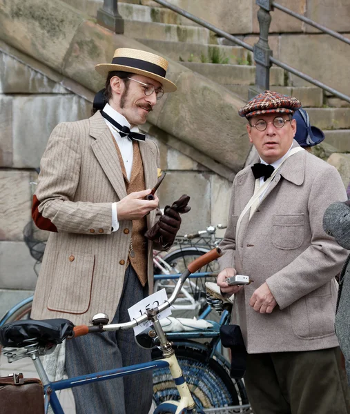 Two elegant men wearing old fashioned clothes