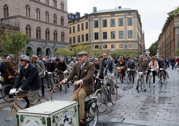 Group of elegant cycling people wearing old fashioned tweed clot