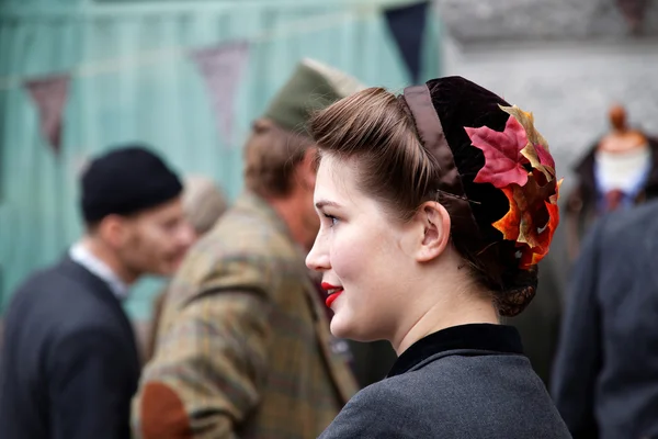 Smiling girl in profile wearing old fashioned tweed clothes