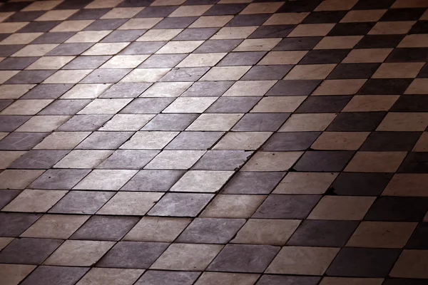 Old retro floor made of dark and bright squares
