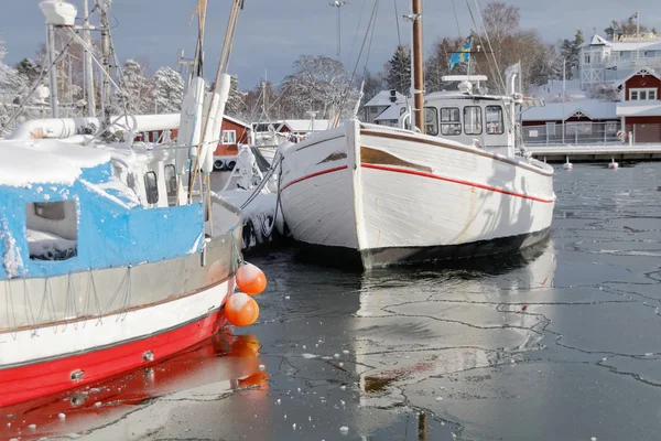 Fishing boats boat in the small harbor during winter time