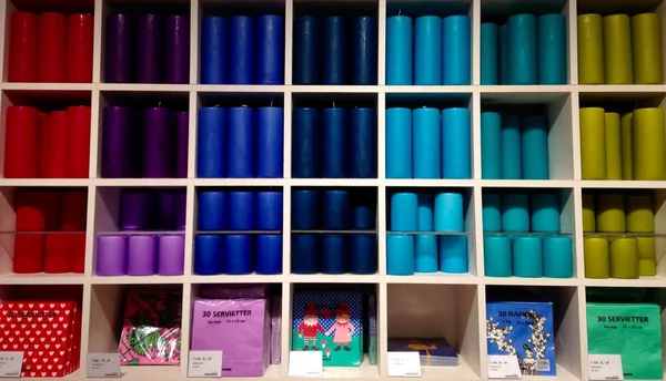 Colourful candles on shelves