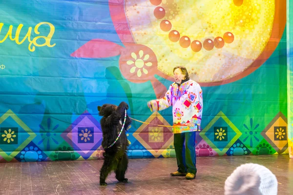 Maslenitsa (pancake week). The animal trainer with the bear on stage.