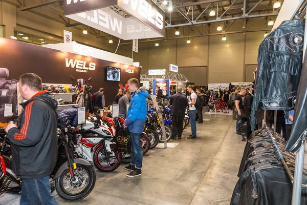 Motopark-2015 (BikePark-2015). The exhibition stand of Wels. Customers visiting the exhibition stand.