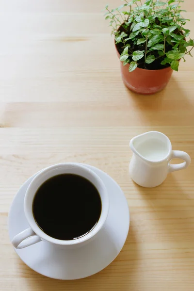 Coffee and milk on wooden table