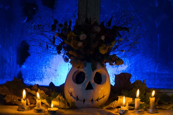 Photo of pumpkin of a vase with the flowers for a holiday Halloween