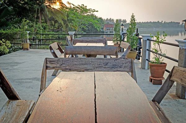 Wooden chairs and tables in garden restaurant