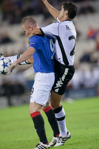 Ricardo Costa (R) and Kenny Miller (L) during the game