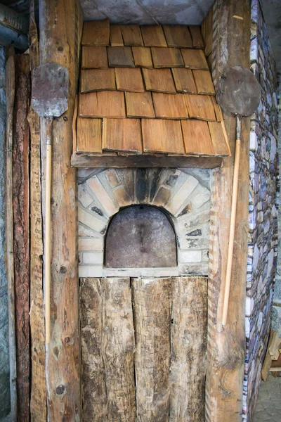 Detail of an outdoor wood-burning oven.