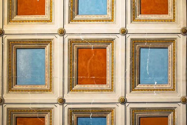 Square orange and blue painted on the ceiling.