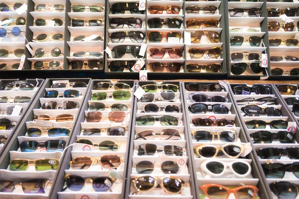 Stall exhibits many colorful vintage sunglasses.