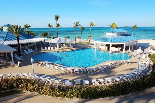 Melia Nassau Beach Resort, Bahamas - 10th of April, 2016: Several families enjoy their holidays in the swimming pool of this all-inclusive resort, placed close to a caribbean beach in Nassau