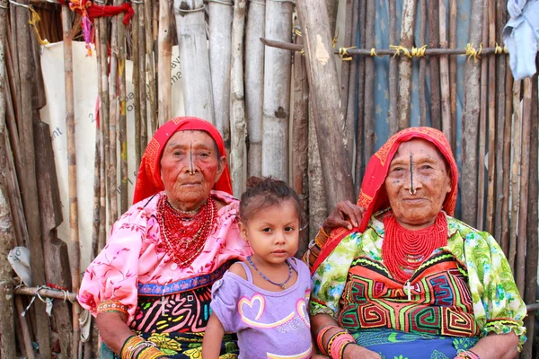 Playón Chico village, Panama - August, 4, 2014: Three generations of kuna indian women in native attire sell handcraft clothes to travelers, San Blas region, Panama.
