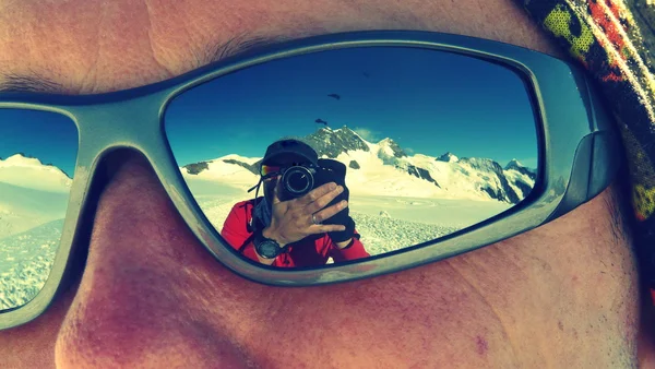 Photographer reflected on sunglasses while climbing Mönch mountain in the Alps, Switzerland