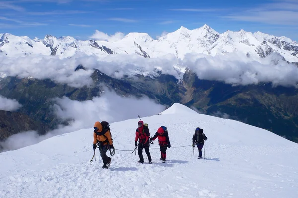 The Alps, Switzerland - July 12th of 2007: Climbers reaching  Weissmies mountain\'s summit (4,017m. - 13,179ft.) a Pennine Alps peak in the canton of Valais near the village of Saas-Fee.
