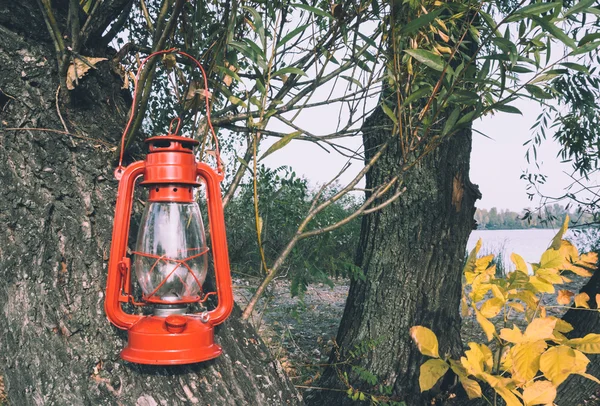 Oil lamp in an autumn garden