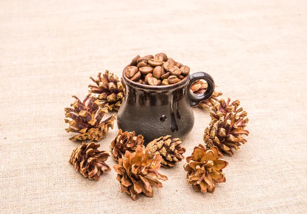 Aromatic coffee beans and pine cones. Winter coffee in a cozy cafe
