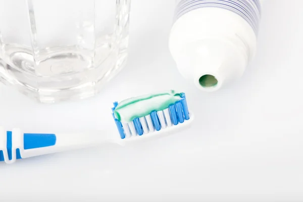 Toiletries, toothpaste on toothbrush, paste tube,
