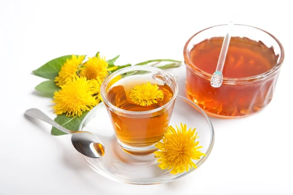 Dandelion honey and herbal tea on white background,