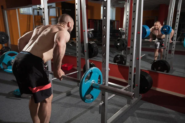 Young adult bodybuilder doing weight lifting