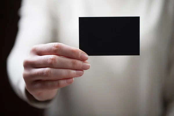 Hand holding blank business card