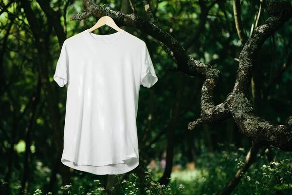 Blank white T-shirt mock up on the tree