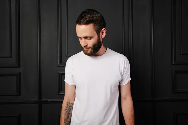 White blank t-shirt with space for your logo on a hipster man wi