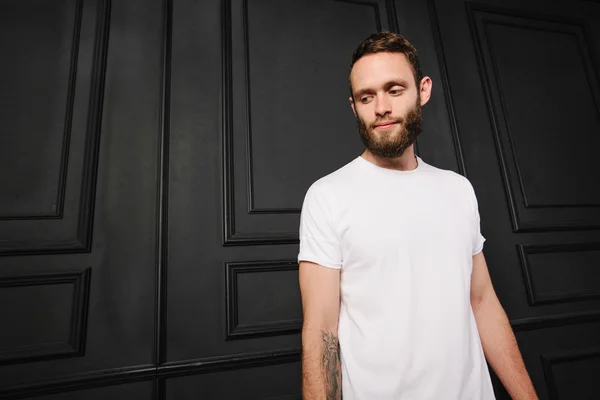 White blank t-shirt with space for your logo on a hipster man wi