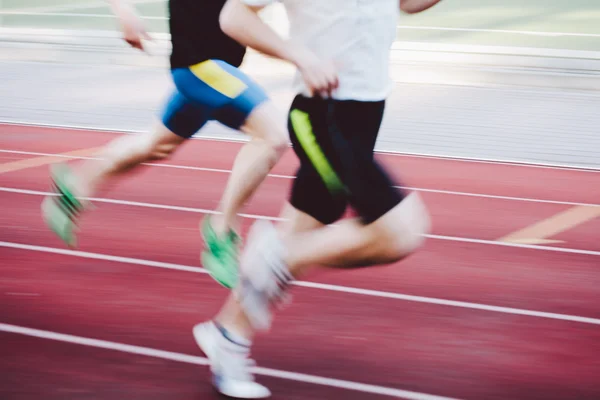 Athletes running on track
