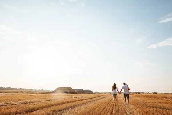 Happy family having fun in a field