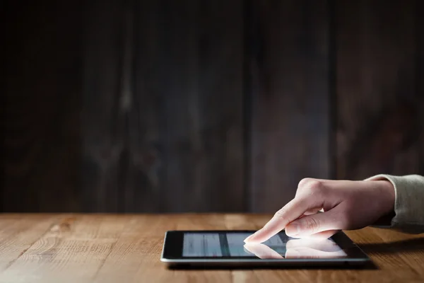 Woman hand presses on screen digital tablet