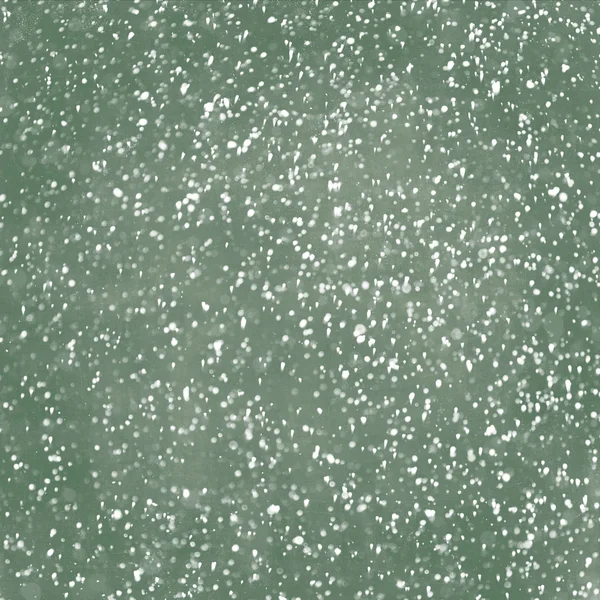 Falling snow with green chalkboard as a background
