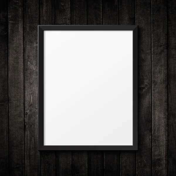 Blank black picture frame on the grunge wood texture. background