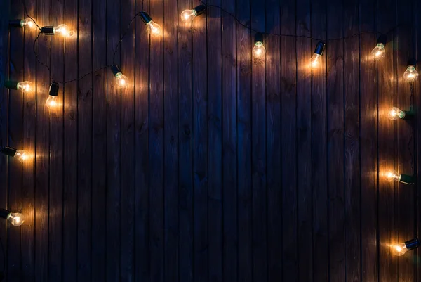 Light bulbs on dark Wooden Background real image
