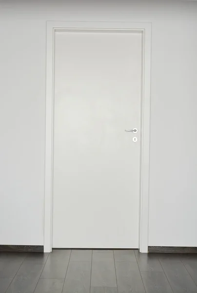 White door set in white wall