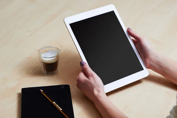 Woman holds mobile tablet