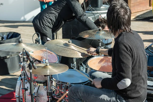 Black hair drummer during outdoor concert