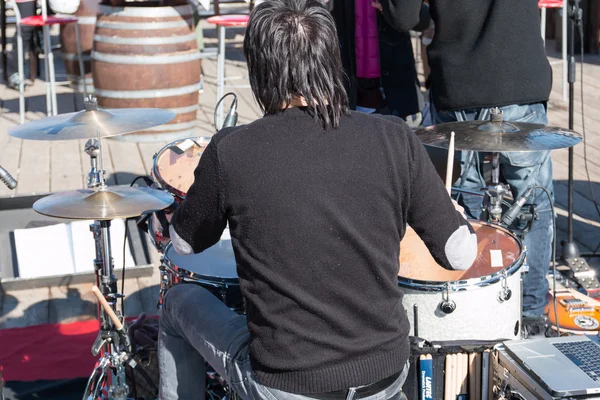 Black hair drummer during outdoor concert