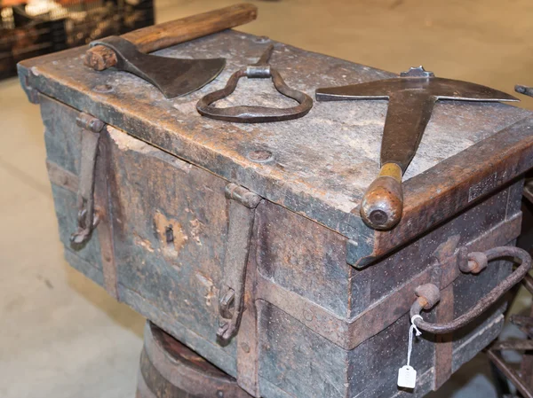 Old rural rusty tools above antique wooden box