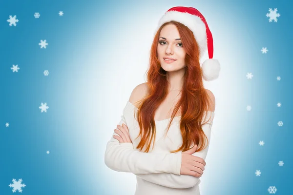 Casual dressed sexy redhead woman in Santa hat