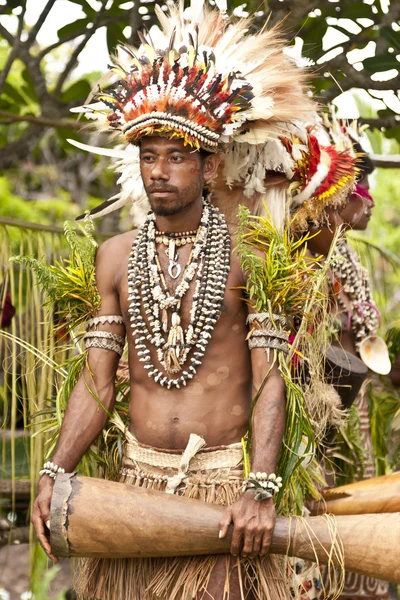 Tufi Papua New Guinea 4 December 2008 : Young Papuan Korafe tribe warrior wearing traditional bird of paradise feather headdress and body decorations during local festival in his village