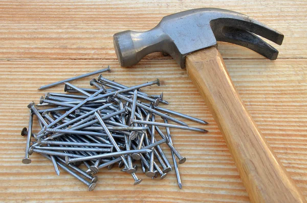 Claw hammer and pile of nails